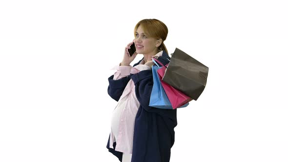 Happy Pregnant Woman Shopping and Speaking By Phone Holding Bags on White Background.