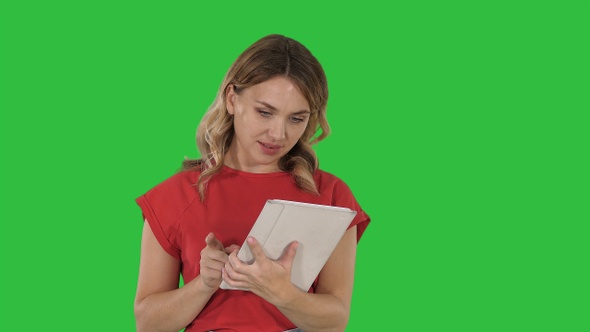 Woman use of tablet on a Green Screen, Chroma Key