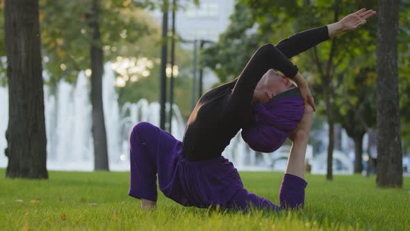 Muslim Islamic Girl in Hijab Trainer Guru Yoga Master Woman Doing Stretching Exercises in Park on