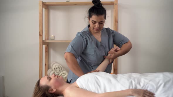 Massage Concept Masseur Doing Wellness Massage to Woman in Spa Salon Massaging Hand Young Woman