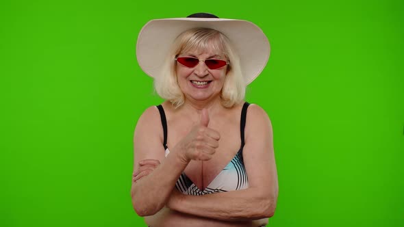 Senior Woman Tourist in Swimsuit Bra and Red Sunglasses Looking at Camera Smiling on Chroma Key