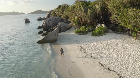 Aerial view of a person walking on the beach of Anse Lazio, Seychelles.