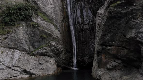 Seductive beauty of a highland waterfall with shiny green water in lost area in ledro