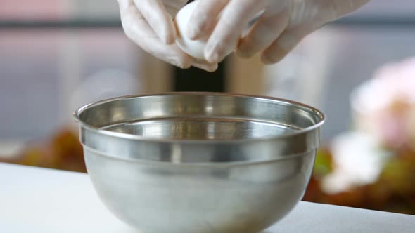 Hands Breaking an Egg.