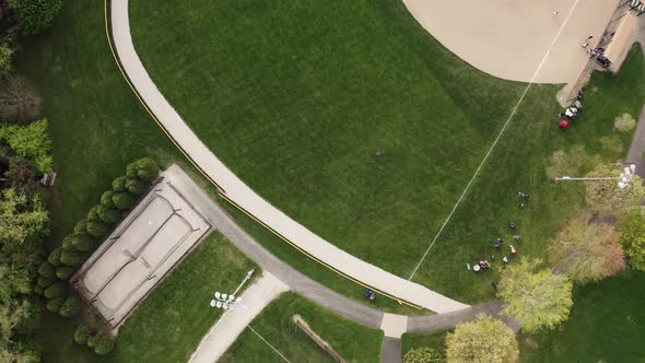 Aerial Drone View of Kids Play Baseball Field at Park on Sunny Day