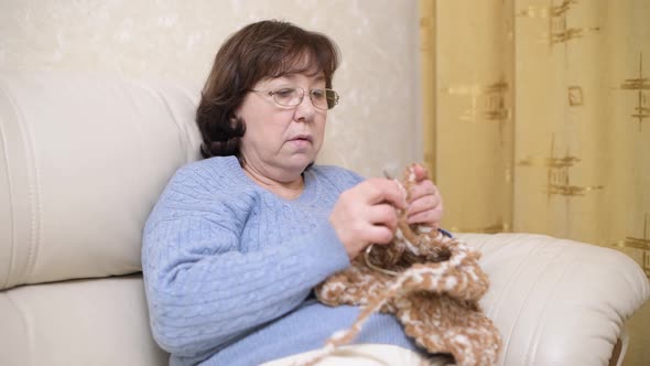 close-up of a woman knitting a scarf