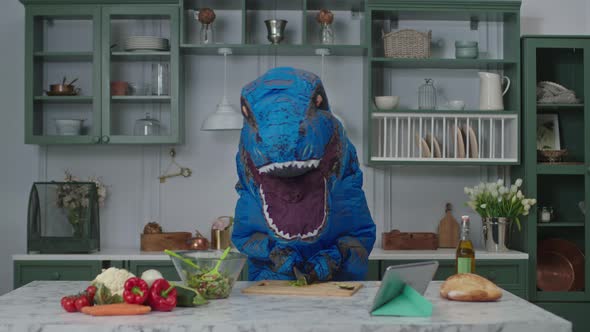 Big Blue Dinosaur Slices Food and Starts to Dance in Kitchen