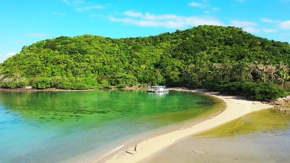 Vivid colors of beautiful bay with calm green water washing white sandy beach on tropical island wit