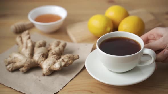 Closeup of Pouring Freshly Brewed Vitamin Tea with Ginger and Lemon