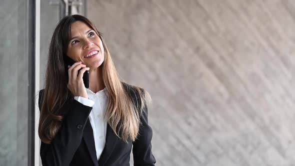 Close Up, Smiling Businesswoman in Suit. Businesswoman Talking Phone Outdoors