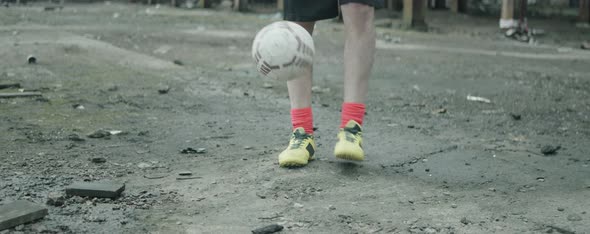 Footballer Juggling Soccer Ball in Abandoned Factory Building