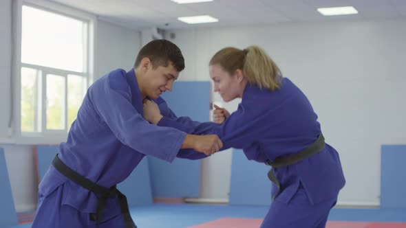 Two Jujutsu Athletes Practicing Takedown