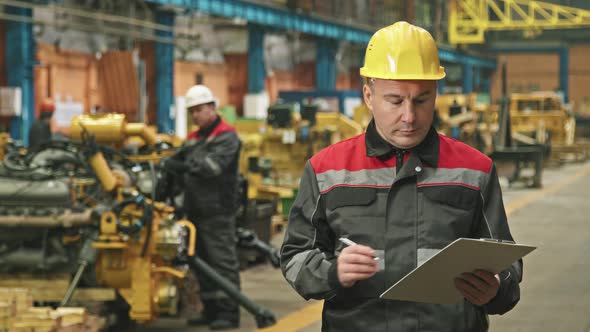 Portrait Of Serious Foreman At Tractor Plant