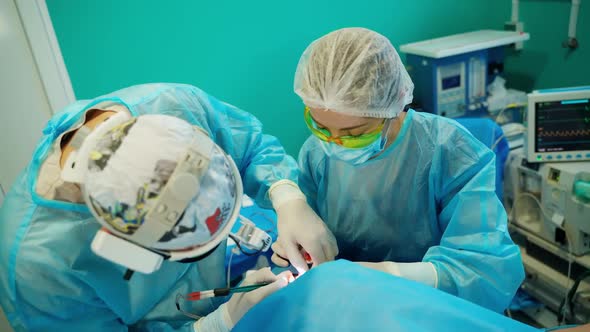 Doctors with tools in hands. Group of surgeons in operating room with surgery equipment