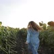 Curly Girl Running on Yellow Sunflower Field - VideoHive Item for Sale
