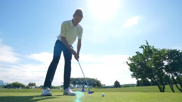 A Man Is Scoring While Playing Golf