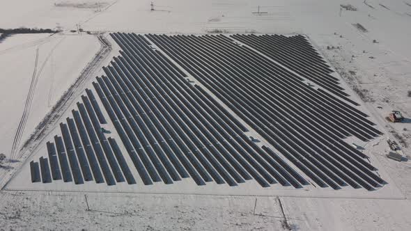 Aerial Perspective Solar Panel Farm Green Energy at Winter Snow Sunny Day Drone Shot of Ecology