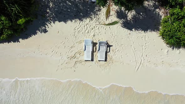 Aerial drone view panorama of tranquil seashore beach break by blue green sea and white sandy backgr