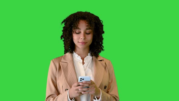 Cheerfull Black Lady Walking and Texting on a Green Screen Chroma Key