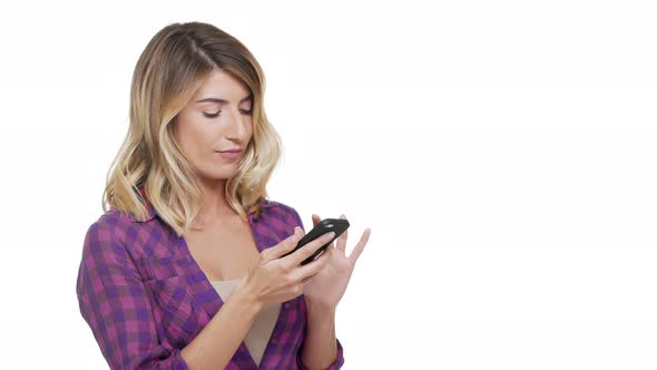 Halfturn Portrait of Young Caucasian Woman with Trendy Hair Wearing Plaid Shirt Using Cell Phone