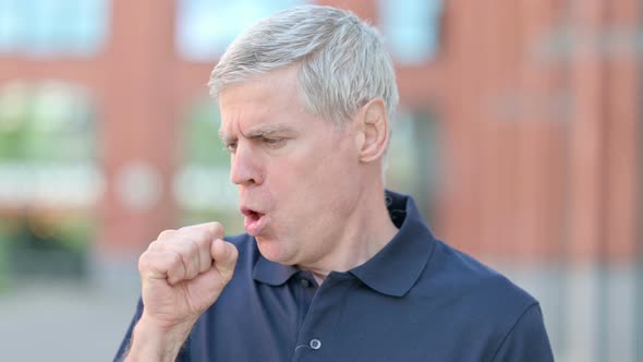 Outdoor Portrait of Sick Middle Aged Man Having Coughing