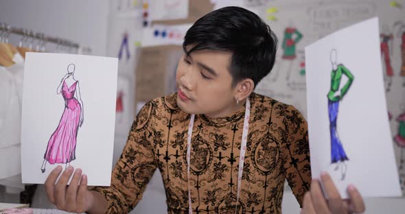 Fashion designer man showing a sketch of clothing