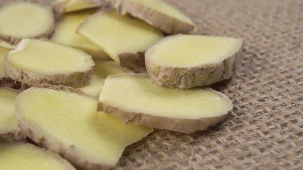 Ginger root in slices on sackcloth