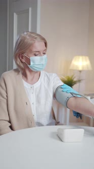 The Doctor Examines the Old Woman and Measures Her Pressure