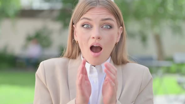 Outdoor Portrait of Young Businesswoman Feeling Surprised