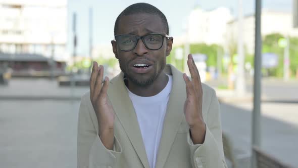 Portrait of Disappointed African Man Reacting to Loss Outdoor