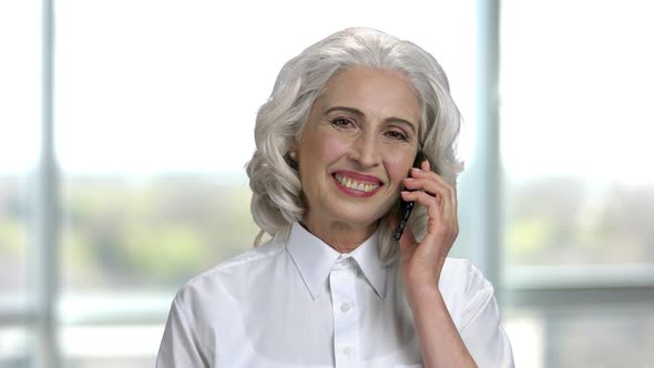 Portrait of Happy Senior Lady Talking on Phone and Laughing