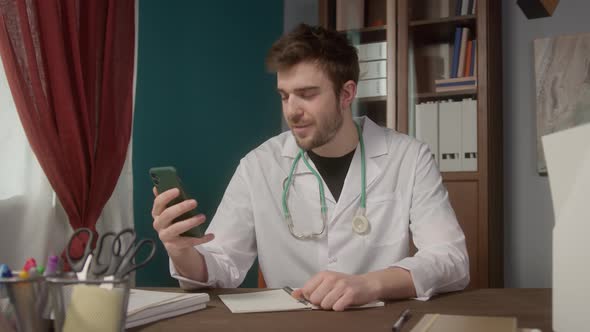 Doctor Wearing Medical Gown Consultation Video Conference in Video Chat Medical App