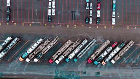 Car Transporter Trucks Stand on Huge Parking Lot Aerial View