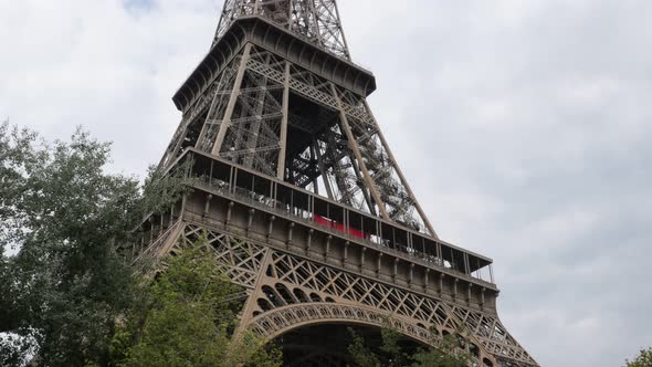 Tour Eiffel Paris France in front of clouds by the day 4K 2160p 30fps UltraHD slow tilt  footage - L