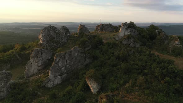 Drone Flight Over Rocky Hilltop At Sunset