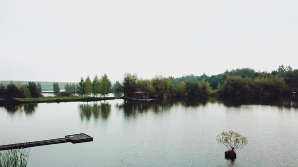 beautiful view of the river with a wooden arbor and forest around. Summer landscape.