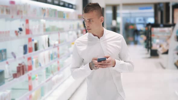 Cute Caucasian Guy Mystery Shopper Analyzes the Prices of Goods