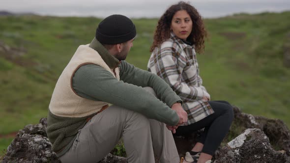 Couple Sitting Together On Rocks In Thingvellir