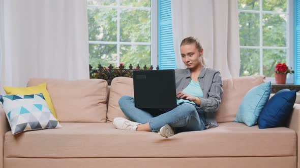 Happy Woman Stretching Sit on Comfortable Couch with Laptop