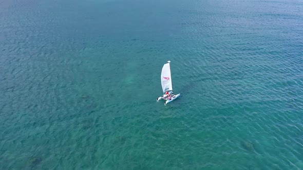 Aerial top down shot of Catamaran Sailing boat cruising on Caribbean Sea near PLAYA NUEVA ROMANA in