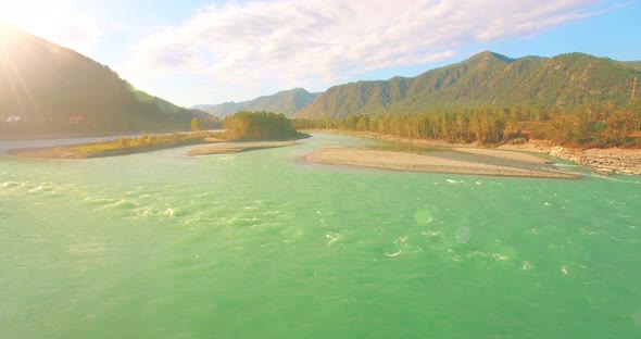 Low Altitude Flight Over Fresh Fast Mountain River with Rocks at Sunny Summer Morning.