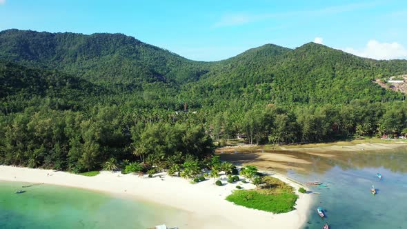 Aerial top down abstract of idyllic lagoon beach holiday by turquoise water and bright sandy backgro