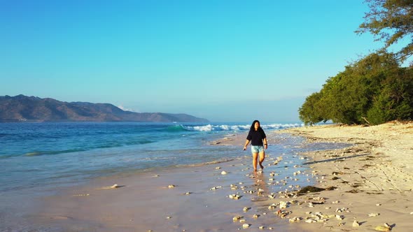 One girl relaxing on exotic island beach trip by transparent ocean with white sandy background of th