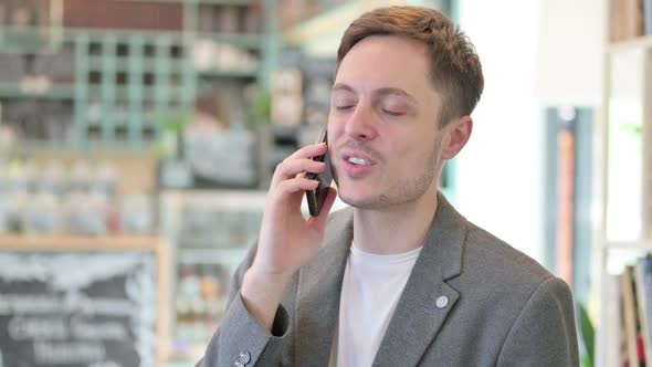 Portrait of Young Man Talking on Phone