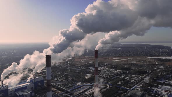 Industrial emissions of smoke from factory pipes in industrial zone