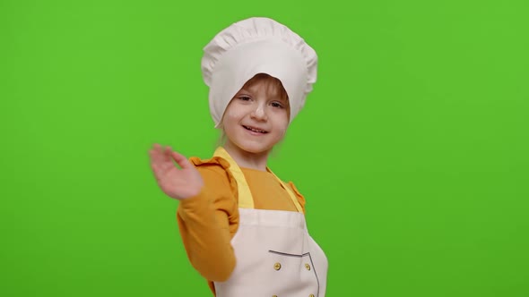 Funny Child Girl Kid Dressed Cook Chef Baker in Apron and Hat Dancing Fooling Around Making Faces