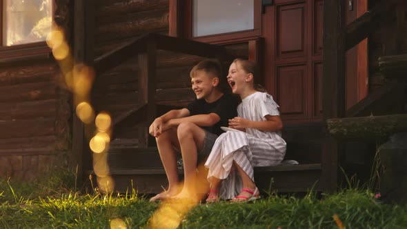 Kids with Pancakes Talking Outside House