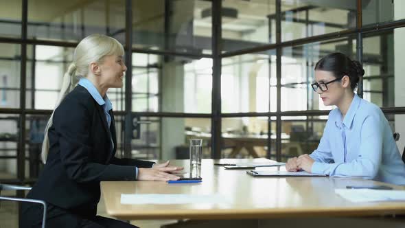 Female Boss Shaking Hand of Young Manager Approving Business Deal, Partnership