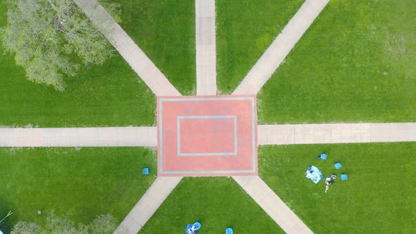 Top down aerial of college university campus. Student relax on the grounds. Interesting artistic pat