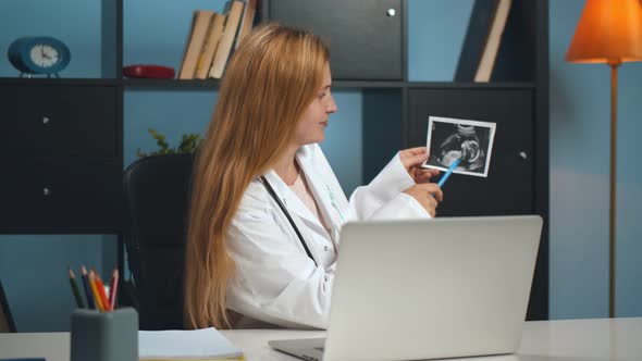 Female Doctor Gynecologist Working in Clinic Consulting Patient Online